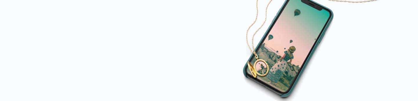 Gold Locket rests on a mobile phone